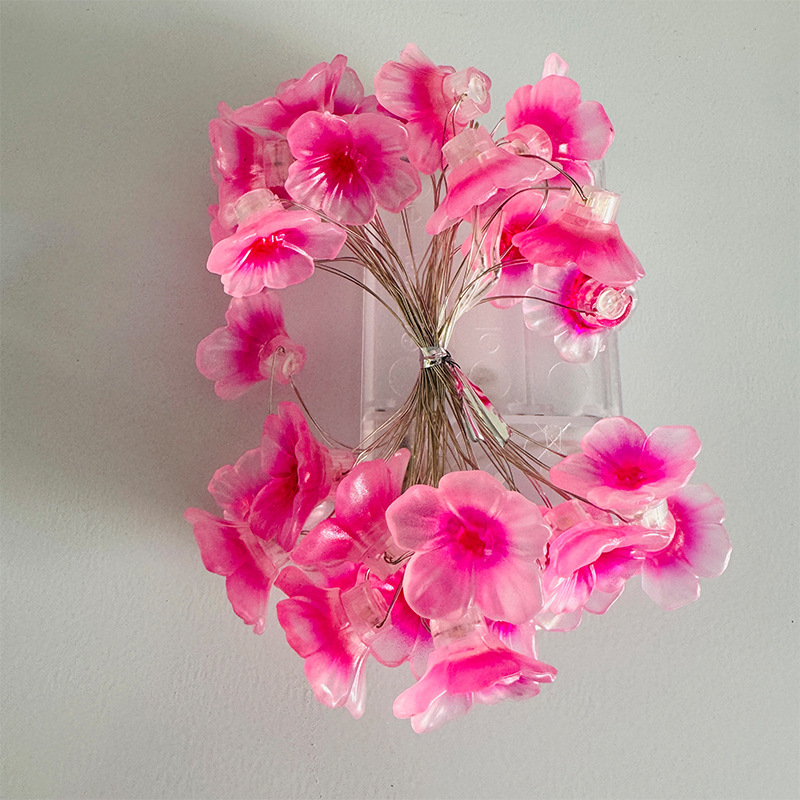 Vario laidininko LED girlianda, gėlių žiedlapių formos, maitinama baterijomis, rankinis jungiklis, IP42, tarnavimo trukmė apie 2000 valandų, dekoracijoms kieme ir miegamajam