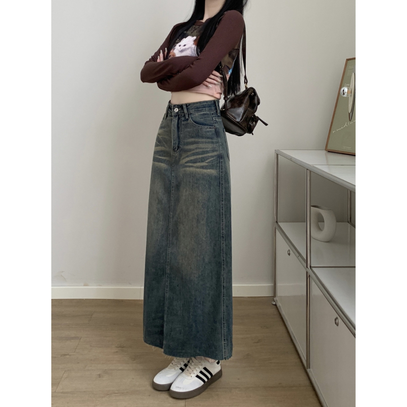 Ženska traper suknja, visokim strukom, A-linija, srednje duljine, obrub na kraju, sastav: pamuk 50–70%, poliester 30–50%