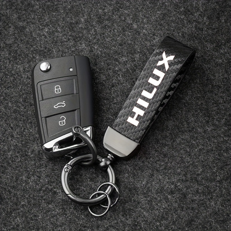 Raktų dangtelis Toyota Hilux Prado modeliams – ultrafininė pluošto oda, anglies pluošto tekstūra, minimalistinis stilius, 360° sukimas, pritaikomas