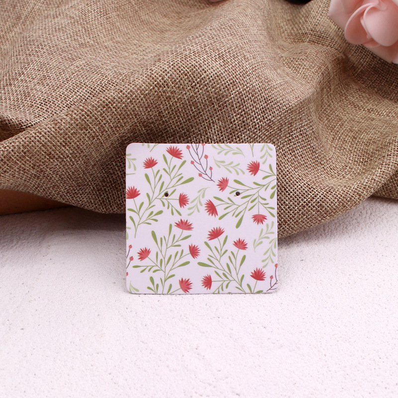 Komi auskarų ekspozicinė kortelė su 400 g vario plokštele, spalvotas spausdinimas, juvelyriniai dirbiniai