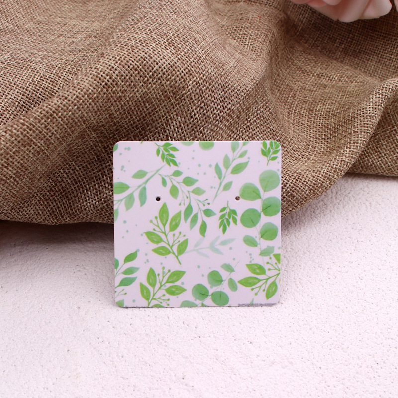 Komi auskarų ekspozicinė kortelė su 400 g vario plokštele, spalvotas spausdinimas, juvelyriniai dirbiniai