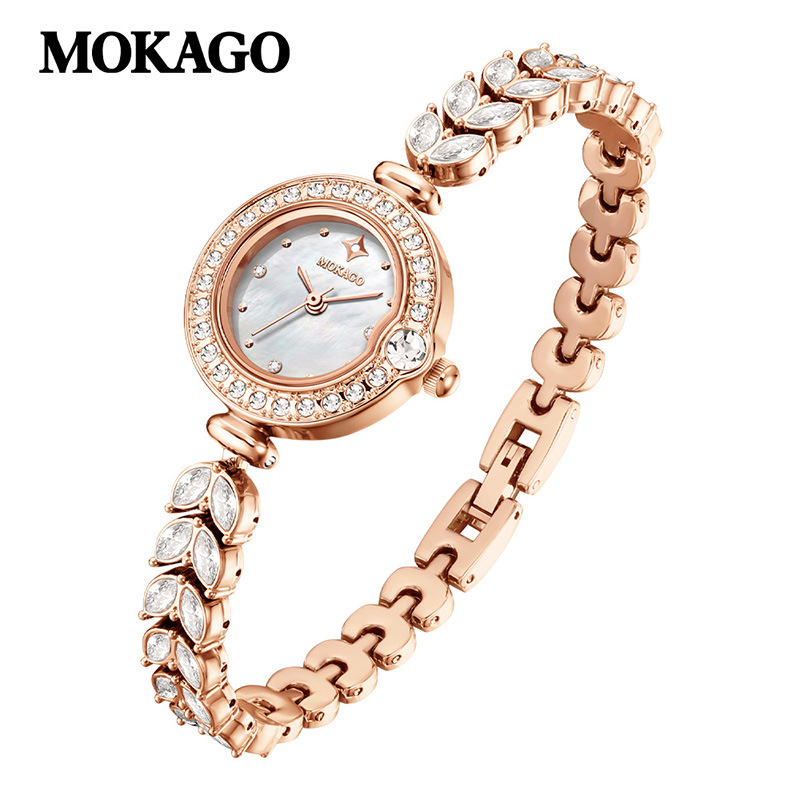 Naise kvartsikell teemantidega kaunistusega ja vasest kettaga kalasaba kujul, ümmargune kellakera (kvartsliikumine; teemantidega kaunistus; vasest kett kalasaba kujul; veekindlus 30 m; ümmargune kellakera)