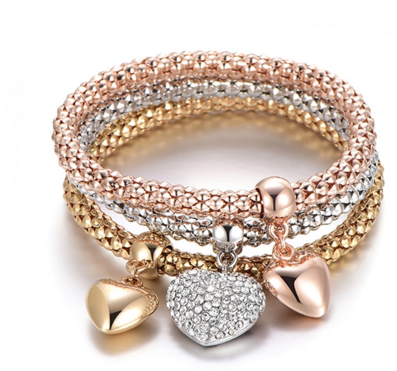 Ženska narukvica — trobojna legura, elastična, lanac u stilu popcorn, privjesak srce sa kamenčićima