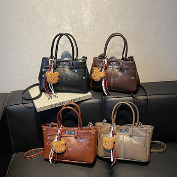 Rokassoma Kelly stilā, PU materiāls, horizontāla kvadrāta forma, aizvēršana ar latch, iekšējā rāvējslēdzēja kabata, poliestera oderējums