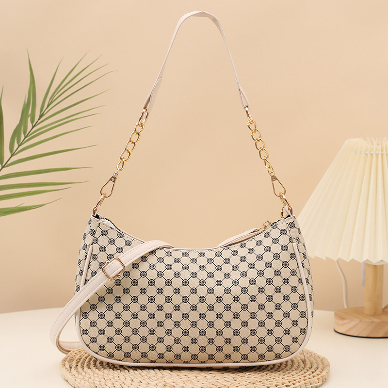 Eleganti PU crossbody krepšys su retro spauda, kompakti stačiakampis formos; turi telefonų kišenę ir dokumentų kišenę; užsegama užtrauktuku; dvigubos peties juostos; tinkama kasdieniam dėvėjimui.