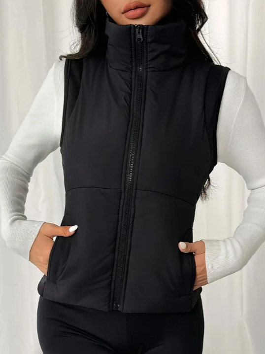 Ženski bezruk vest s uspravnim ovratnikom, prednji zatvarač, uži u struku, normalne duljine