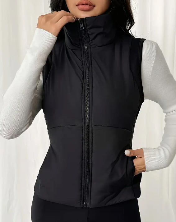 Ženski bezruk vest s uspravnim ovratnikom, prednji zatvarač, uži u struku, normalne duljine