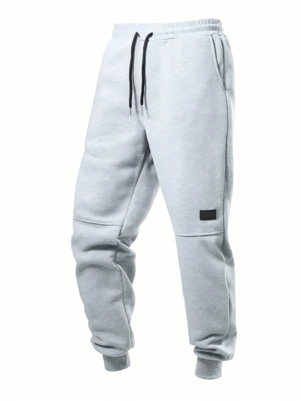 Férfiaknak laza szabású sportnadrág, középmagas derékkal és húzózsinóros zárással | fleece bélés; poliészter anyag (Laza szabás; Középmagas derék; Húzózsinóros zárás; fleece bélés; Téli mindennapi viselet)