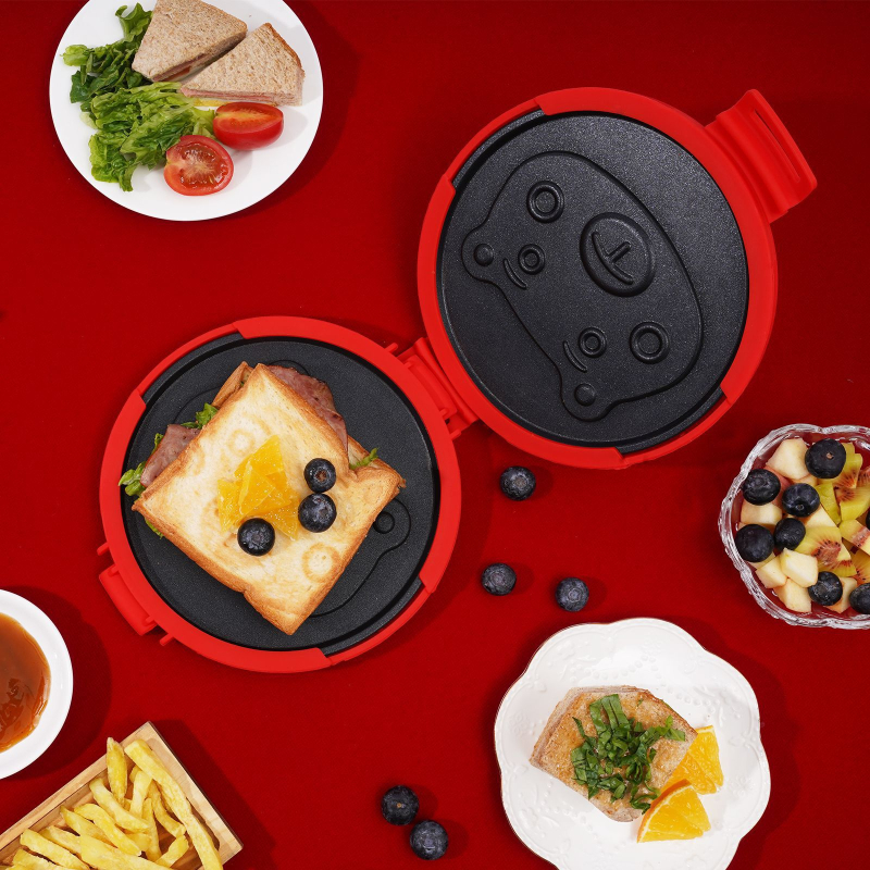 Mikrovalna sendvič preša s odvojivim silikonskim posudom, kružnog oblika, dvostrana; model SN005D; funkcije: zagrijavanje, pećenje mesa, prženje jaja; težina 887 g; poklopac za prašinu uključen