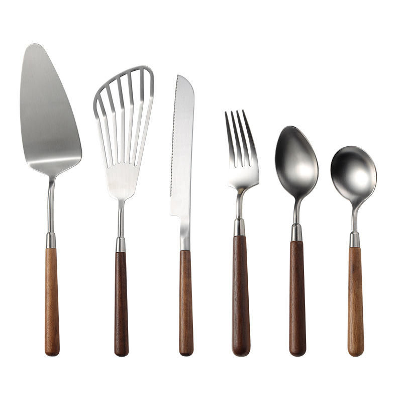 304 nerezovej ocele západné jedlá s orechovým držadlom, leštený povrch. Obsahuje: nôž, vidlica, lyžica, lopatka na tortu, nô na chlieb, motýľová lopatka, malá lyžička