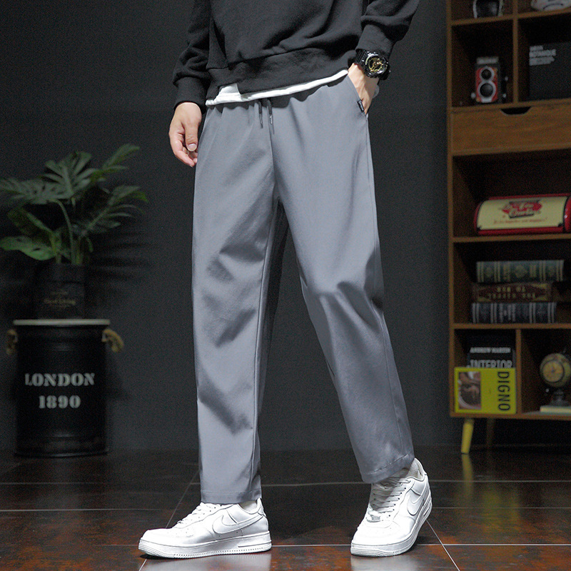 Pánske voľné športové nohavice, ľahký polyester s elastanom, stredný pás, šnúrka na stiahnutie, potlač s písmenami, leto