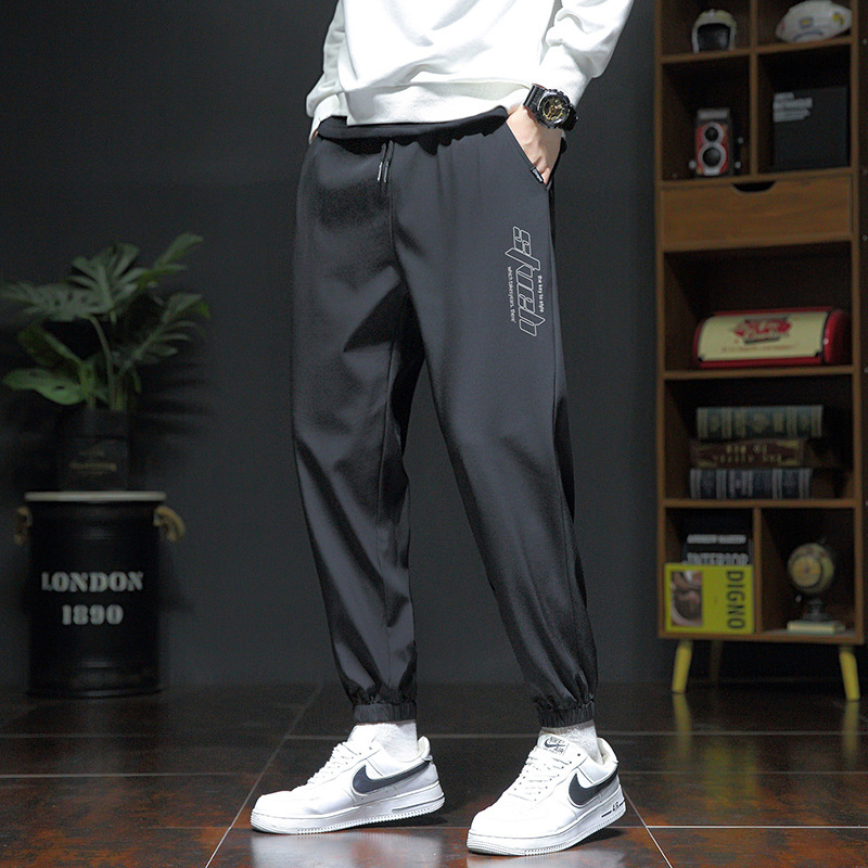 Pánske voľné športové nohavice, ľahký polyester s elastanom, stredný pás, šnúrka na stiahnutie, potlač s písmenami, leto