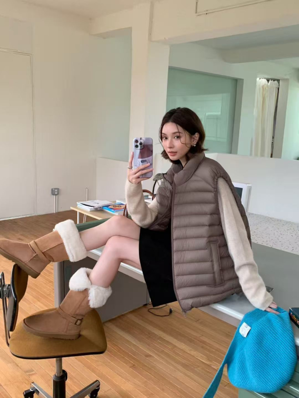 Dámska peľová vesta so stojacim golierom, zipsom, voľným strihom, výplňou z bieleho kačacieho peria, obsah peria 86–90%