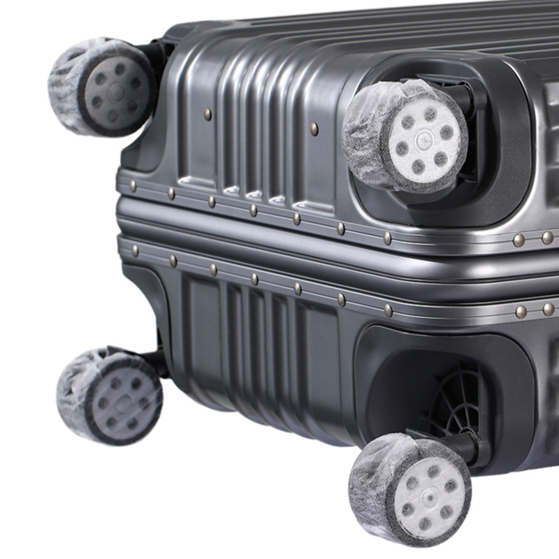 Univerzálne jednorazové ochranné krytie kolies kufra — netkaná textília, elastické, vhodné pre kufre, stoly a kreslá