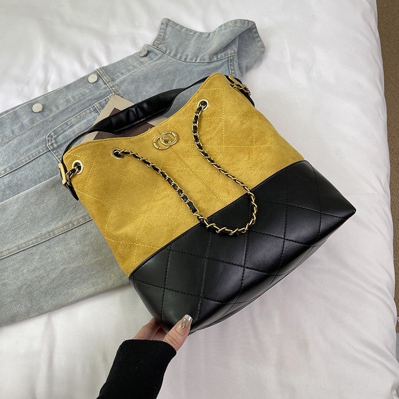 PU bőrű vödör alakú táska dekoratív hímzéssel, belső zsebek telefonhoz, dokumentumokhoz és kamerához, mágneses zár, poliészter bélés