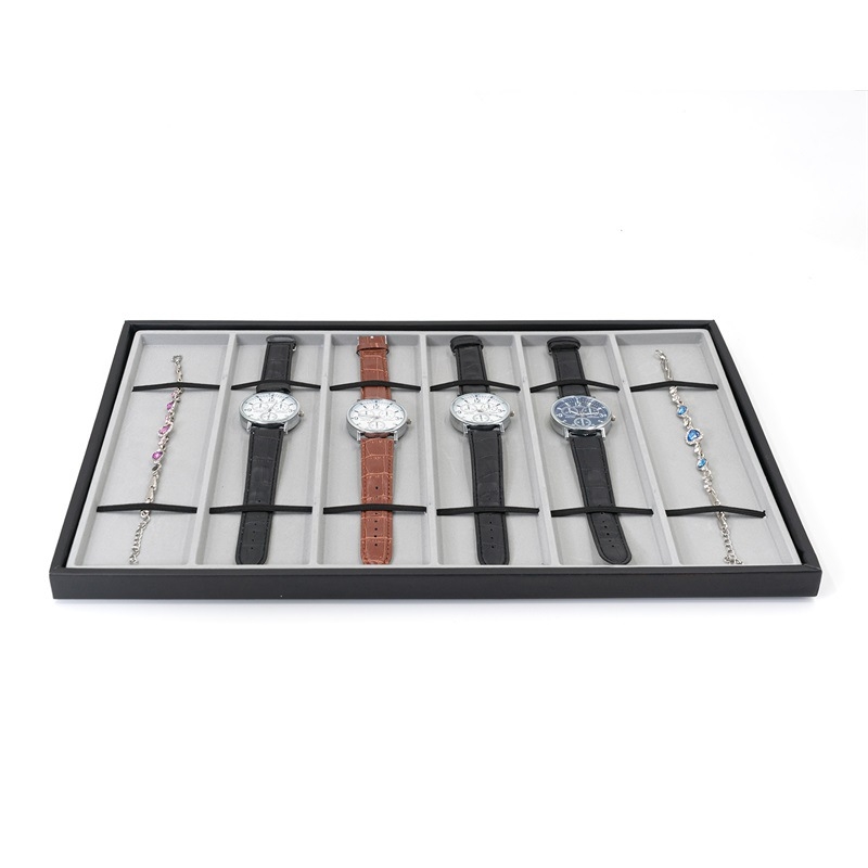 Pulksteņu displeja statīvs ar 10 nodalījumiem – pulksteņu uzglabāšana; materiāli: MDF, blister, PU āda, flanelis; tolerances 3–5 mm; juvelierizstrādājumu iepakojums