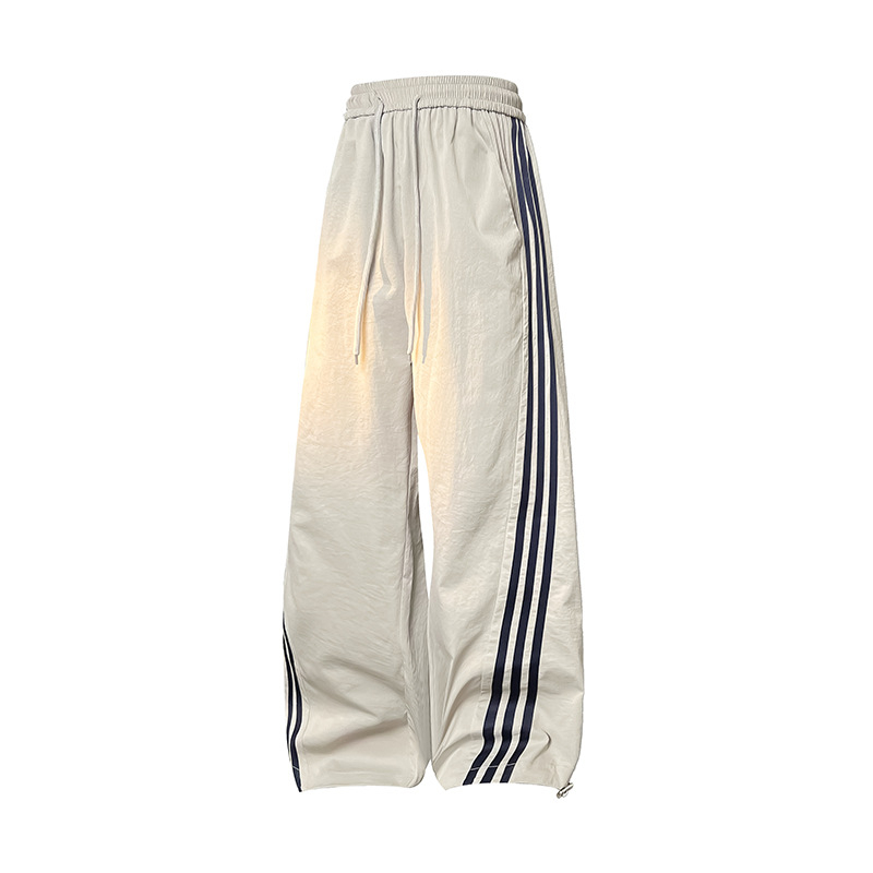 Meeste vabaajarõivaste püksid kontrastsete triipudega, kõrge vöökoht, lai lõige, nööriga kinnituv sulgemine, fleece vooder