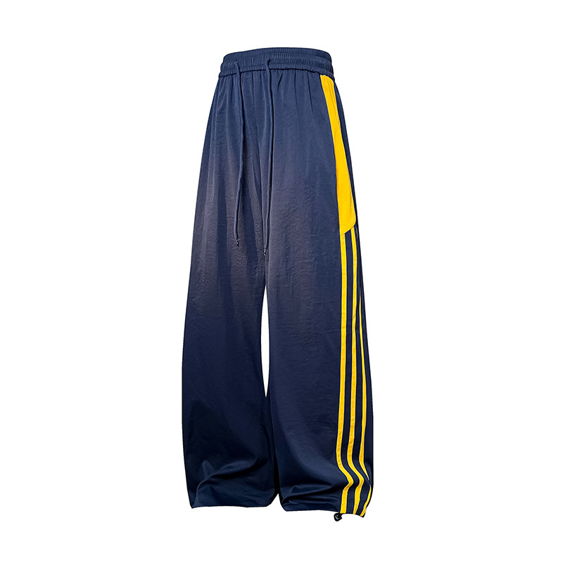 Meeste vabaajarõivaste püksid kontrastsete triipudega, kõrge vöökoht, lai lõige, nööriga kinnituv sulgemine, fleece vooder