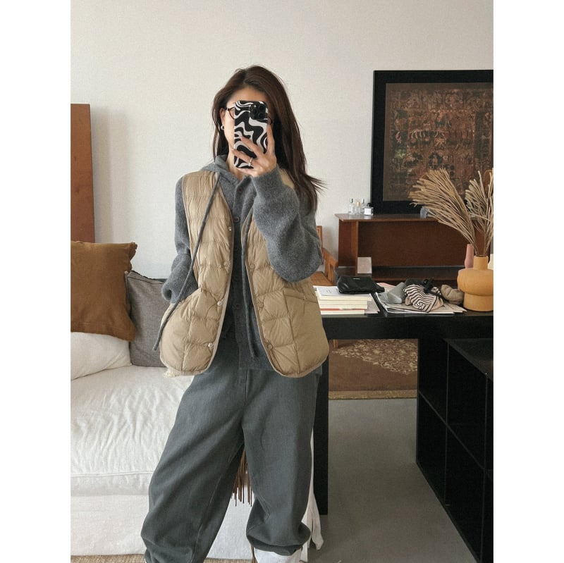 Moteriška lengva be rankovių pūkinė liemenė, 86-90% balto antis pūko, nailono išorinis audinys, V-kaklo linija, užsegimas vienoje eilėje sagomis, ruduo–žiema