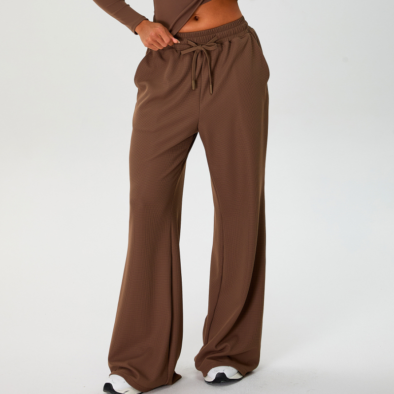 Moterų laisvo kirpimo sportinės kelnės su aukštu liemeniu ir platėjančiais kelnais, raišteliu; nailono audinys su spandeksu 90% pamušalu, drėgmės nukreipimas ir kvėpavimas, tinka bėgiojimui ir fitnesui