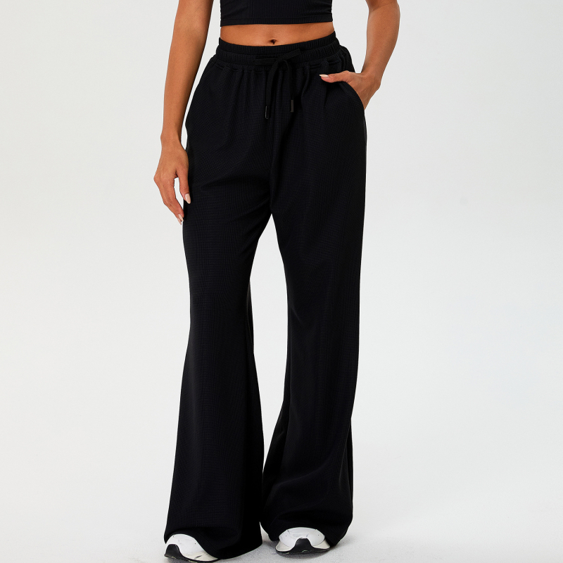 Moterų laisvo kirpimo sportinės kelnės su aukštu liemeniu ir platėjančiais kelnais, raišteliu; nailono audinys su spandeksu 90% pamušalu, drėgmės nukreipimas ir kvėpavimas, tinka bėgiojimui ir fitnesui