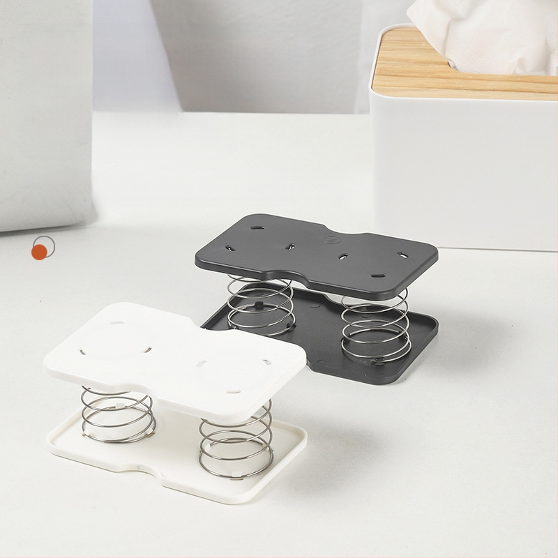 Pakeliama servetėlių dėžutės spyruoklinė atrama, skirta pritraukti prie apatinės spyruoklinės stalčiaus dėžutės apatinės atramos, laikymo dėžutės spyruoklinė lapo pakėlimo elastinė atrama