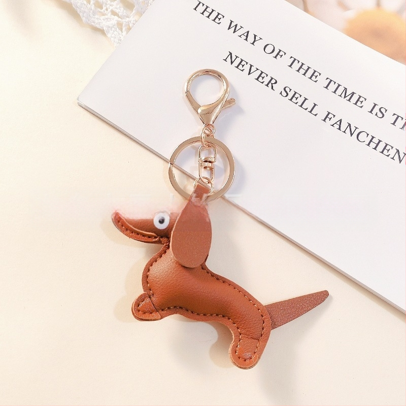 Határokon átnyúló Amazon új PU tacskó kutya kulcstartó kézi kötél táska függő baba kézitáska dekoratív bőr medál Tide