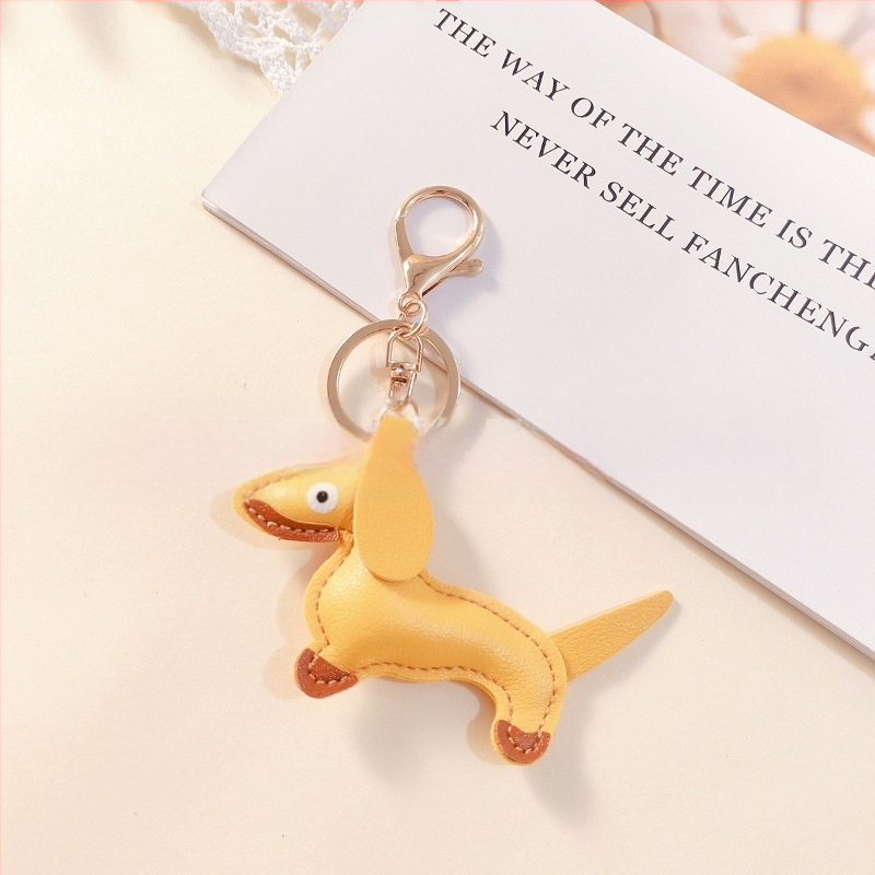 Határokon átnyúló Amazon új PU tacskó kutya kulcstartó kézi kötél táska függő baba kézitáska dekoratív bőr medál Tide