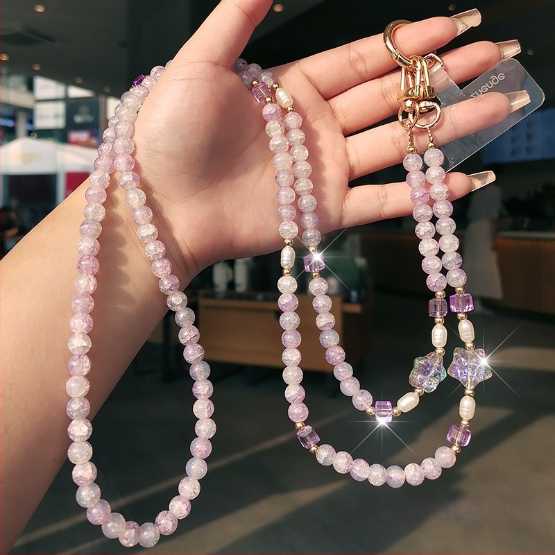 Ilgas mobiliojo telefono dirželis su įtrūkusiais karoliukais, krištolo karoliukų grandinėlė, išskirtinis jūrų žvaigždės karoliukų maišelis su grandinėle, pakabukas mobiliojo telefono dėklui, apsaugantis nuo pametimo.