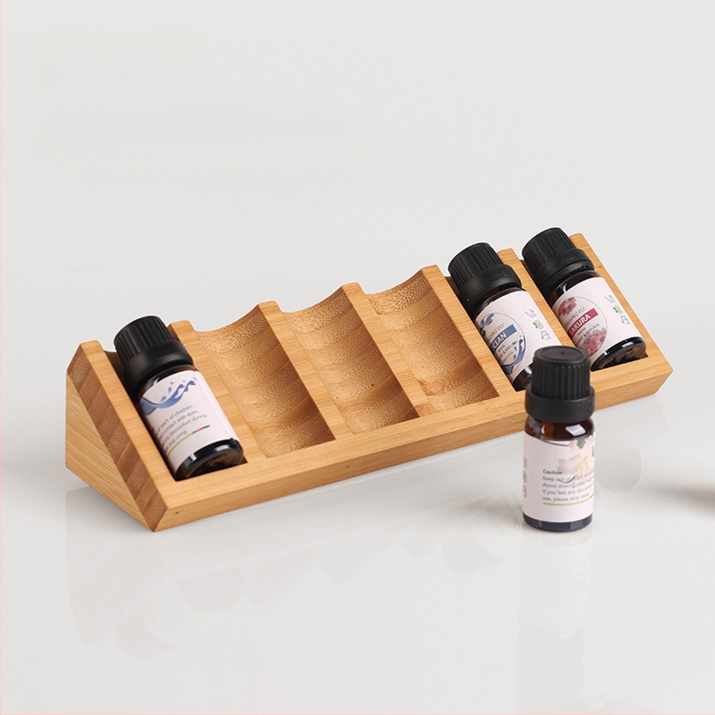 Allika eeterlike õlide riiul lauaarvutile Mini kolmnurkne eeterlike õlide pudelite hoiustamise ja viimistlusega alus bambusest ja puidust eeterlike õlide pudelite huulepulga vitriin