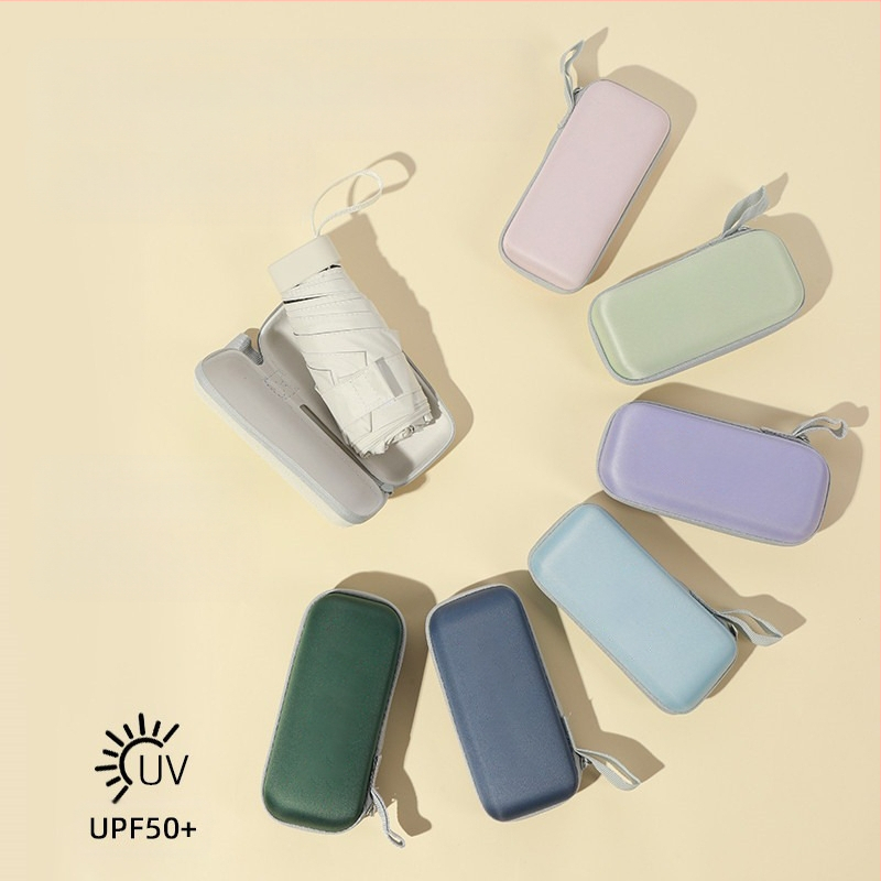 Kapsulinio tipo skėtis moterims, 6 rėmų, 210T audinys, UPF >40, rankinis atidarymas‑uždarymas, svoris 220 g