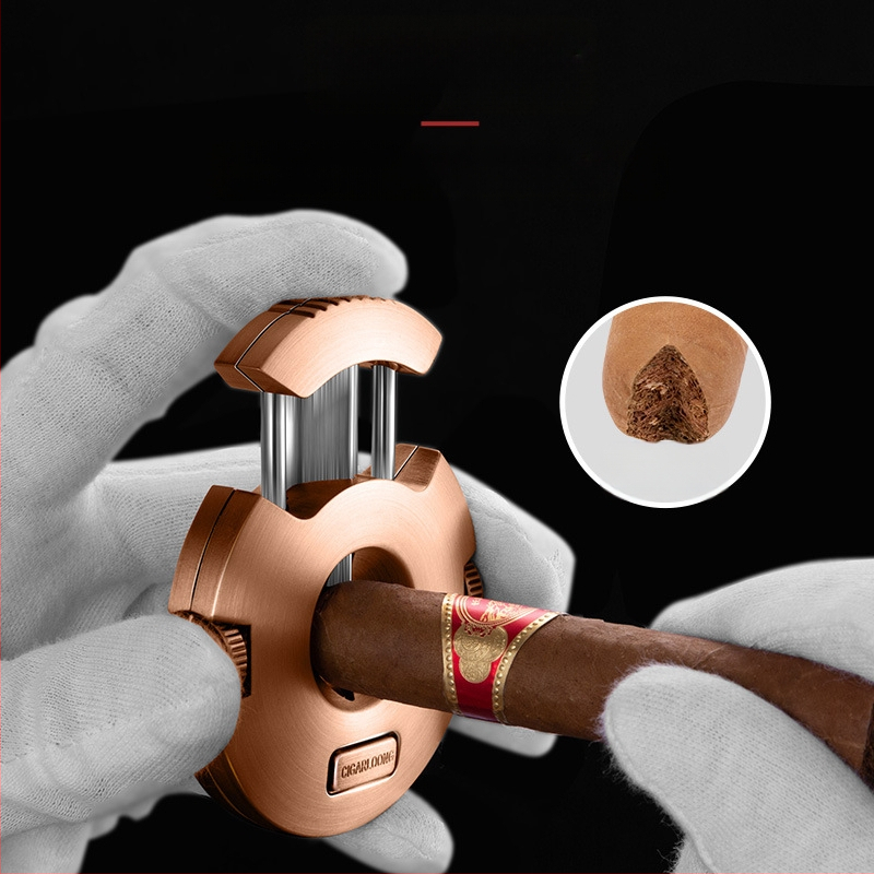 Cigāru šķēres ar V-veida nerūsējošā tērauda asmeni un slēgtu divu diametru urbjamo asmeni – roku darbs, pielāgojamas