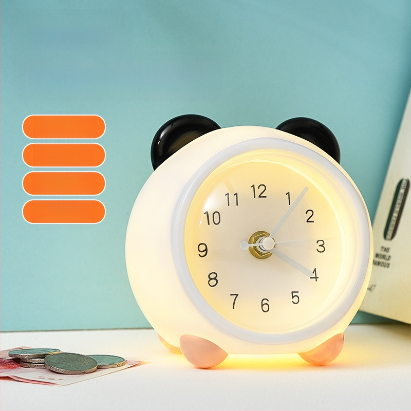 Vaikų stalo laikrodis su taupymo dėžute ir naktiniu apšvietimu, baterijomis maitinamas mechaninis judesys, vienpusis plastikinis korpusas, animacinio stiliaus