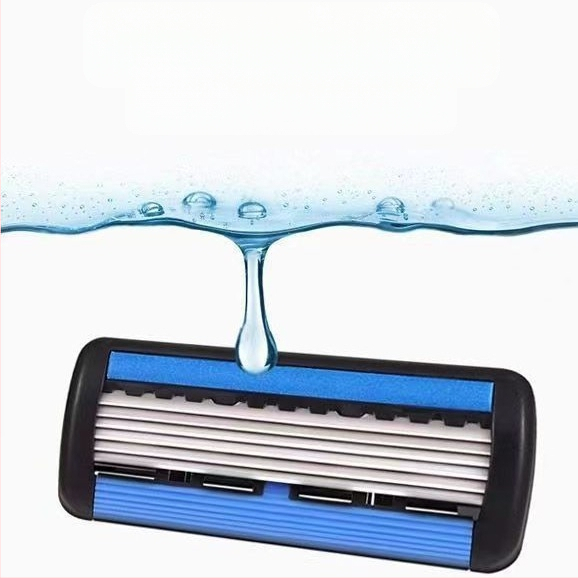 Rokas manuālais 6-slāņu drošības skuveklis vīriešiem ar maināmu galvu un skrāpējumu aizsargājošām asmeņiem