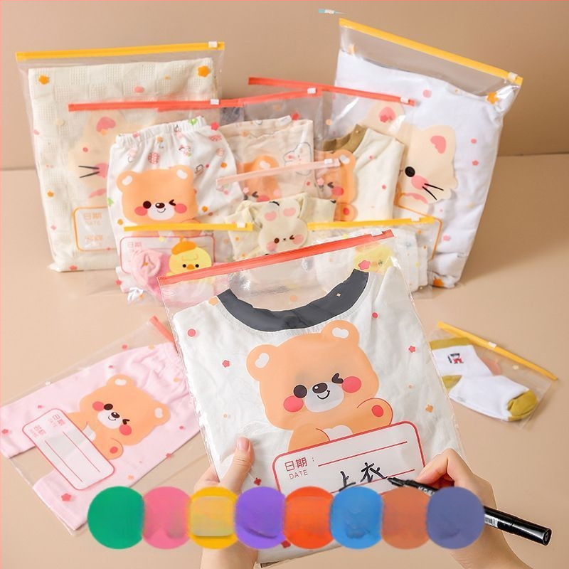 Drēbju uzglabāšanas soma, kubiska PE kārba ar saldu karikatūru dizainu, caurspīdīgs rāvējslēdzējs, putekļu izturīga un noslēgta, daudzfunkcionāla lietošanai apģērbam, kosmētikai un personīgajām higiēnas precēm