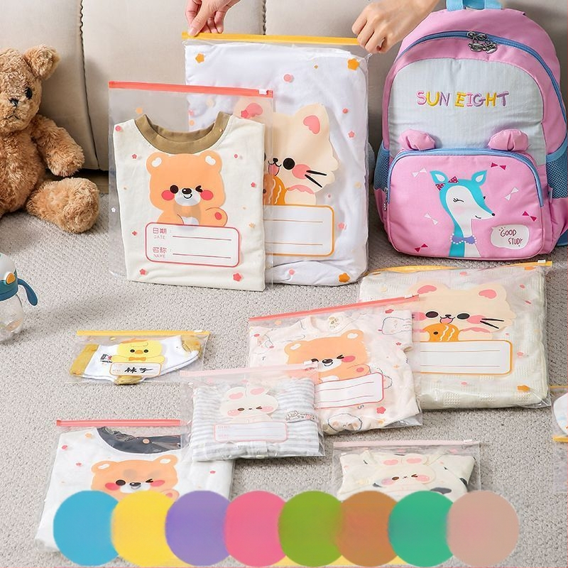 Drēbju uzglabāšanas soma, kubiska PE kārba ar saldu karikatūru dizainu, caurspīdīgs rāvējslēdzējs, putekļu izturīga un noslēgta, daudzfunkcionāla lietošanai apģērbam, kosmētikai un personīgajām higiēnas precēm