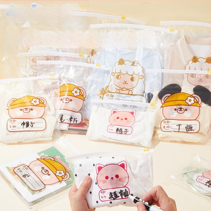 Drēbju uzglabāšanas soma, kubiska PE kārba ar saldu karikatūru dizainu, caurspīdīgs rāvējslēdzējs, putekļu izturīga un noslēgta, daudzfunkcionāla lietošanai apģērbam, kosmētikai un personīgajām higiēnas precēm