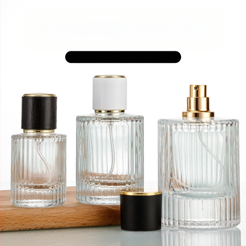Стъклена бутилка за парфюм със винтово гърло, кръгло прозрачно тяло, дебело вертикално ивично стъкло, голям страничен спрей, тежък капак
