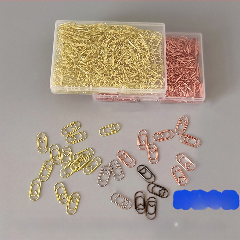 Mini szív alakú papírkapcsok, fém-plasztik felépítés, átlátszó műanyag dobozban – irodai kellékek