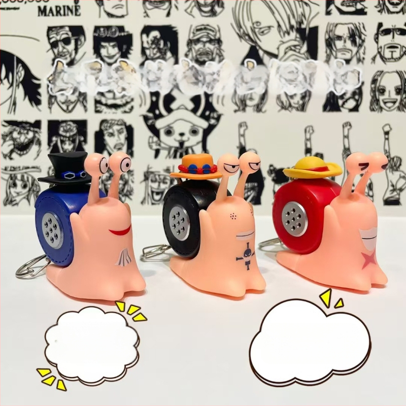 Plastmasas atslēgu piekariņš ar balss pogu un ierakstošu lelli – karikatūriskā stila, relaksējoša rotaļa
