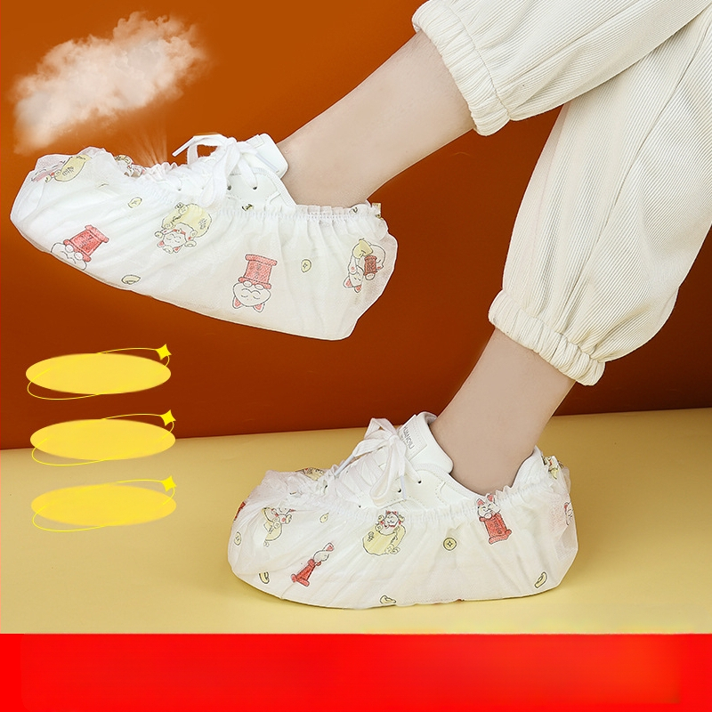 Vienkartiniai batų uždangalai iš netinko audinio, stori, su karikatūriniu atspaudų motyvu, vidiniam naudojimui; logotipo spausdinimas galimas