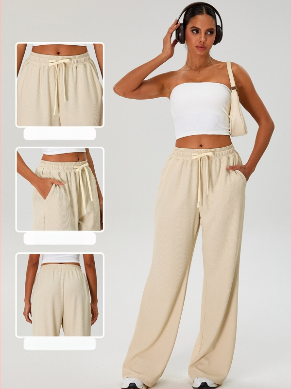 Moterų laisvo kirpimo sportinės kelnės su aukštu liemeniu ir platėjančiais kelnais, raišteliu; nailono audinys su spandeksu 90% pamušalu, drėgmės nukreipimas ir kvėpavimas, tinka bėgiojimui ir fitnesui